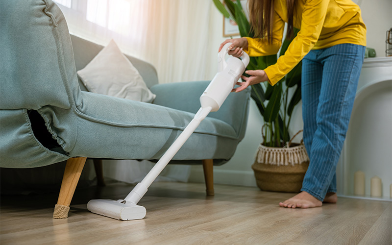 G Journey homeowner vacuuming dust from a dull vinyl floor