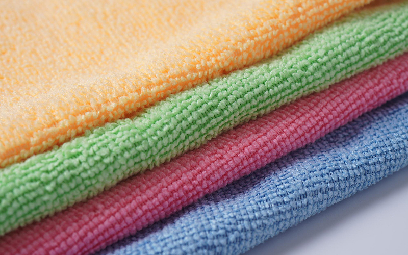 Stacked colorful microfiber cloths ready for effective household cleaning