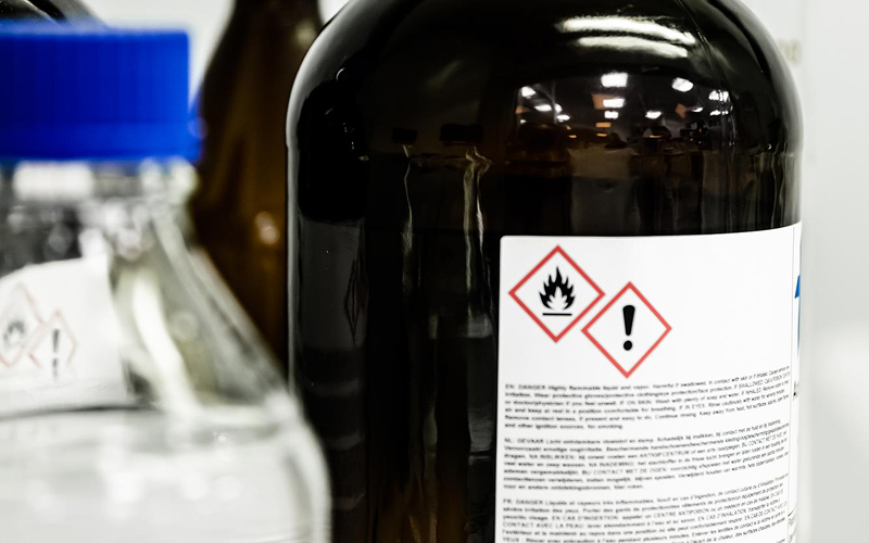 Warning labels on a bottle of flammable cleaning chemicals
